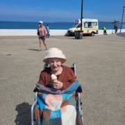 Resident eating an ice cream at the seaside