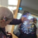 A resident using the new Digital Interactive Screen At Bluebell house